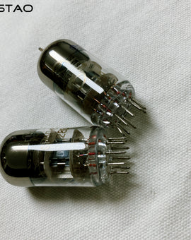 Two silver-colored vacuum tubes, model 6H3n, placed on a light fabric surface.